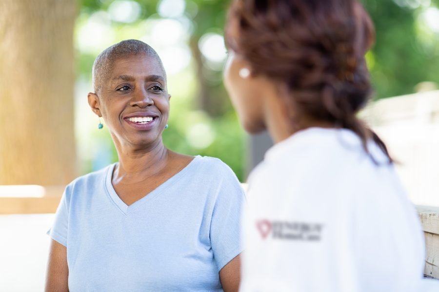 A SYNERGY HomeCare caregiver visiting with a client outdoors