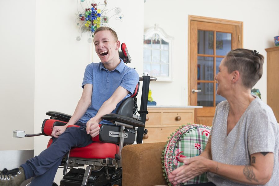 A client and caregiver making music together at home