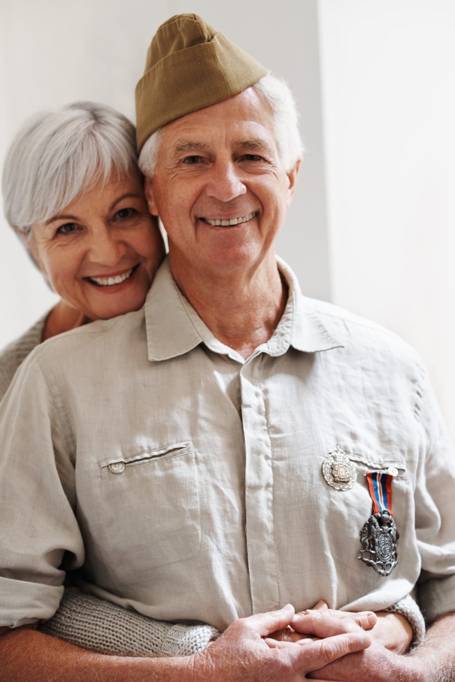 A proud veteran wearing his service medal beside his wife